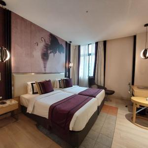 a bedroom with a large bed in a room at BEYZAA HOTEL AND SUITES in Kolkata +87 photos