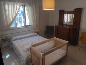 Säng eller sängar i ett rum på Casa di Nonna Mariella