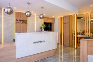 a reception desk in a lobby with a restaurant at DIAMOND luxury Hotel in Antalya