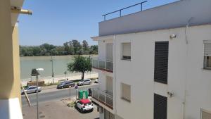 a view of a street from a building with a parking lot at habitación doble a 100m paseo fluvial in Coria del Río
