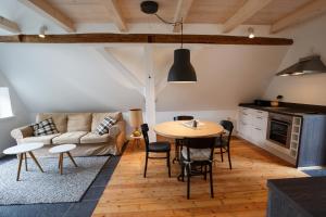 a living room with a table and a couch at Scheune Borgsum in Borgsum