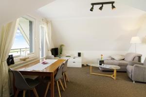 a living room with a table and a couch at Strandhus Uiterst-hörn Utkiek in Baltrum