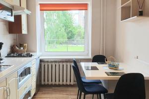 a kitchen with a table and chairs and a window at Studio apartment in Joniškis in Joniškis