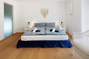 ein Schlafzimmer mit einem großen Bett mit zwei Nachttischen in der Unterkunft Seesehnsucht Höri in Gaienhofen