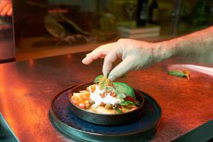 a person is reaching into a bowl of food at UNAHOTELS Varese in Varese