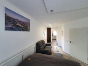 a bedroom with a bed and a chair and a couch at Las Vegas Apartment in Paderborn