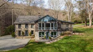 an old stone house on a grassy field at Beech Haven in Beech Mountain