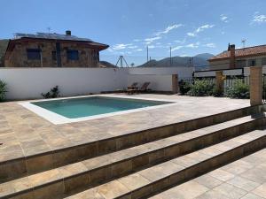 a swimming pool on top of a house at Cortijo Los Pinillos in Pinos Genil