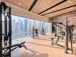 a gym with a view of the city at Welcome Home Apartments - VIDA Marina - Full Marina view - High Floor in Dubai