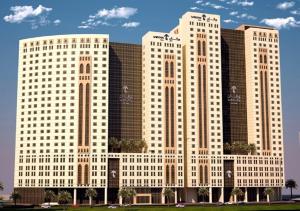 Deux grands bâtiments blancs avec des arbres devant eux dans l'établissement Wirgan Hotel Al Nour, à La Mecque