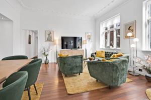 a living room with a table and chairs and a couch at The Modern Breakaway in Aarhus in Aarhus