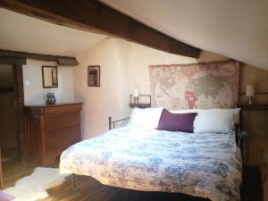 a bedroom with a large bed and a dresser at Les Granges de la Leigne, Ruffec in Condac