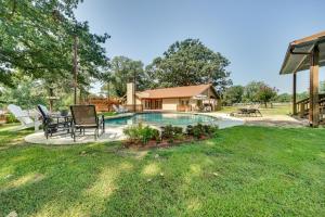 a backyard with a swimming pool and a house at Charming Texarkana Home Lake and Pool Access! in Texarkana