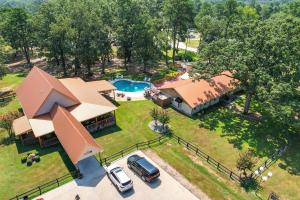 an aerial view of a house with a pool and a yard at Charming Texarkana Home Lake and Pool Access! in Texarkana
