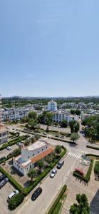 an aerial view of a parking lot in a city at LAMAR SUITES Seafront Apartments in Misano Adriatico