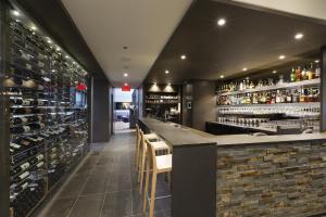 a bar in a restaurant with a wall of wine bottles at Chez Truchon Bistro-Auberge in La Malbaie