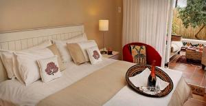 Postel nebo postele na pokoji v ubytování African Breeze Guesthouse