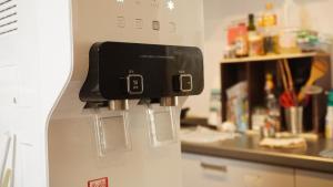 a dispenser on a refrigerator in a kitchen at Fukuoka Guest House Jikka in Fukuoka +37 photos