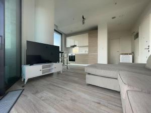 a bedroom with a large bed and a large flat screen tv at Newada Residence 1+1 With Pool View in Istanbul