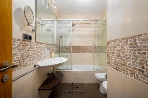 a bathroom with a sink and a shower and a toilet at Lucila Beachfront Pedregalejo By AlohaMálaga in Málaga +29 photos