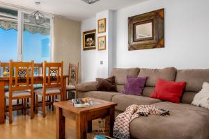 a living room with a couch and a table at Lucila Beachfront Pedregalejo By AlohaMálaga in Málaga
