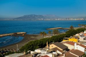 a view of a beach with houses and the ocean at Lucila Beachfront Pedregalejo By AlohaMálaga in Málaga