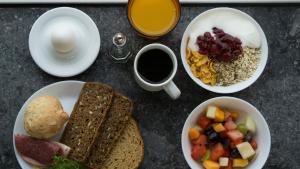 a table topped with bowls of breakfast foods and coffee at Danhostel Aarhus City in Aarhus