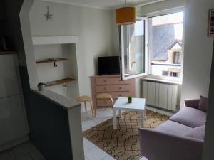 ein Wohnzimmer mit einem Sofa und einem Tisch in der Unterkunft Appartement, port de Binic in Binic