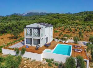 an aerial view of a villa with a swimming pool at Olive grove villa in Plátonas