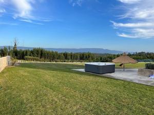 a large grass field with a building in the middle at Quinta do Carregal in Mangualde