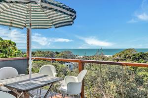 a table and chairs on a balcony with a view of the ocean at Blue Waters in Point Lookout