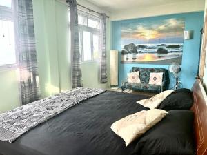 a bedroom with a large bed and a couch at Stunning Apartment castle comfort in Roseau