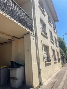 a building with a trash can in front of it at Superbe Appartement in La Côte-Saint-André