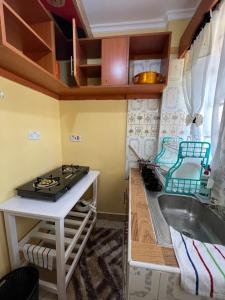 a kitchen with a sink and a stove at Naivasha 1BR Apartment in Naivasha