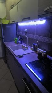 a kitchen counter with a sink and a stove at Apartament - Lisa in Budva