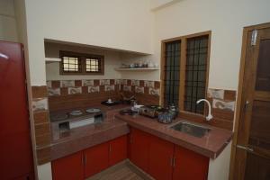 a kitchen with a sink and a counter top at Swasthika Homes in Pīrmed