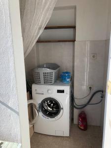 uma máquina de lavar roupa numa pequena cozinha com em apartamento Albufeira, Olhos de Água em Albufeira
