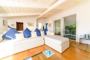 a living room with two white couches and blue pillows at Estate4home - Villa Maria Rosaria in Massa Lubrense +84 photos