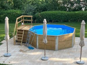 a hot tub with a ladder and a bed in a yard at Landhaus Finest in Altdorf bei Nuernberg