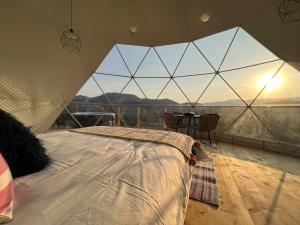 a bedroom with a bed in a tent with a view at Starry Dome - Manta's Retreat Glamping Cornereva in Cornereva