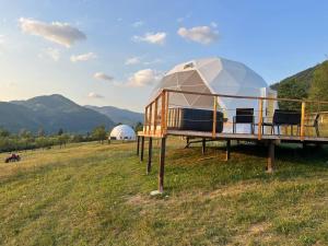 a dome house on a field with mountains in the background at Starry Dome - Manta's Retreat Glamping Cornereva in Cornereva