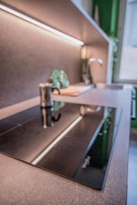 a miniature kitchen with a sink and a faucet at BDC_7 Apartment in Parma