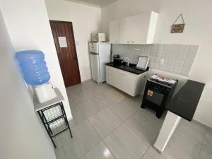 an overhead view of a kitchen with white appliances at Mahalo Beach Residence in Porto De Galinhas