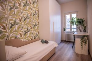 a bedroom with a bed and a wall with a mural at BDC_7 Apartment in Parma