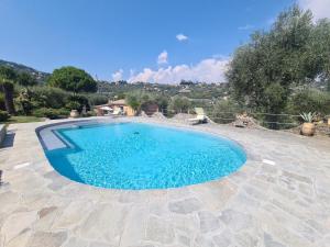 a large blue swimming pool in a yard at Villa Draga by PortofinoVacanze in Santa Margherita Ligure
