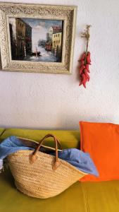 a basket on a couch with a picture on the wall at Apartament - Lisa in Budva