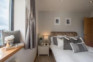 a bedroom with two beds and a window at Seren Las, Tenby in Tenby