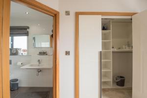 a bathroom with a sink and a mirror at Seren Las, Tenby in Tenby