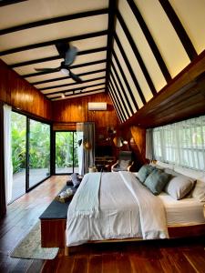 a bedroom with a large bed in a room at Kabinji Bali in Tampaksiring