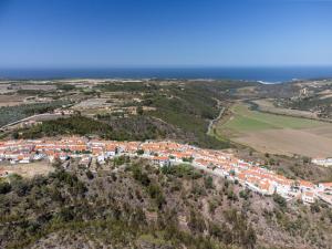 an aerial view of a village on a hill next to the ocean at Windmill Escape - Onda Townhouse in Odeceixe